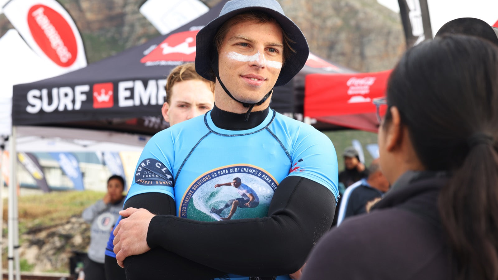 Surfers at the beach wearing broad spectrum UVA & UVB sunscreen protection