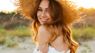 A lady with sensitive skin wearing a wide brim hat