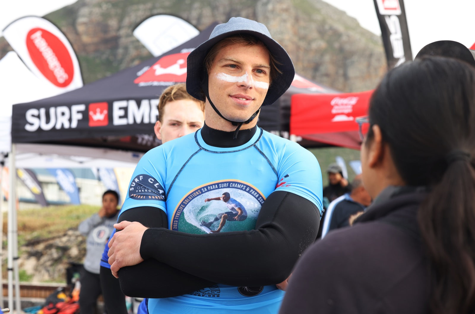 Surfers at the beach wearing broad spectrum UVA & UVB sunscreen protection