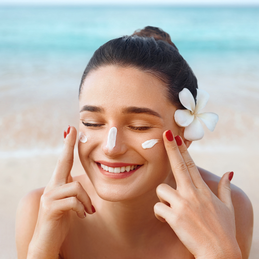 Applying sunsceen on the beach to someone with sensitive skin