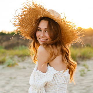 A lady with sensitive skin wearing a wide brim hat