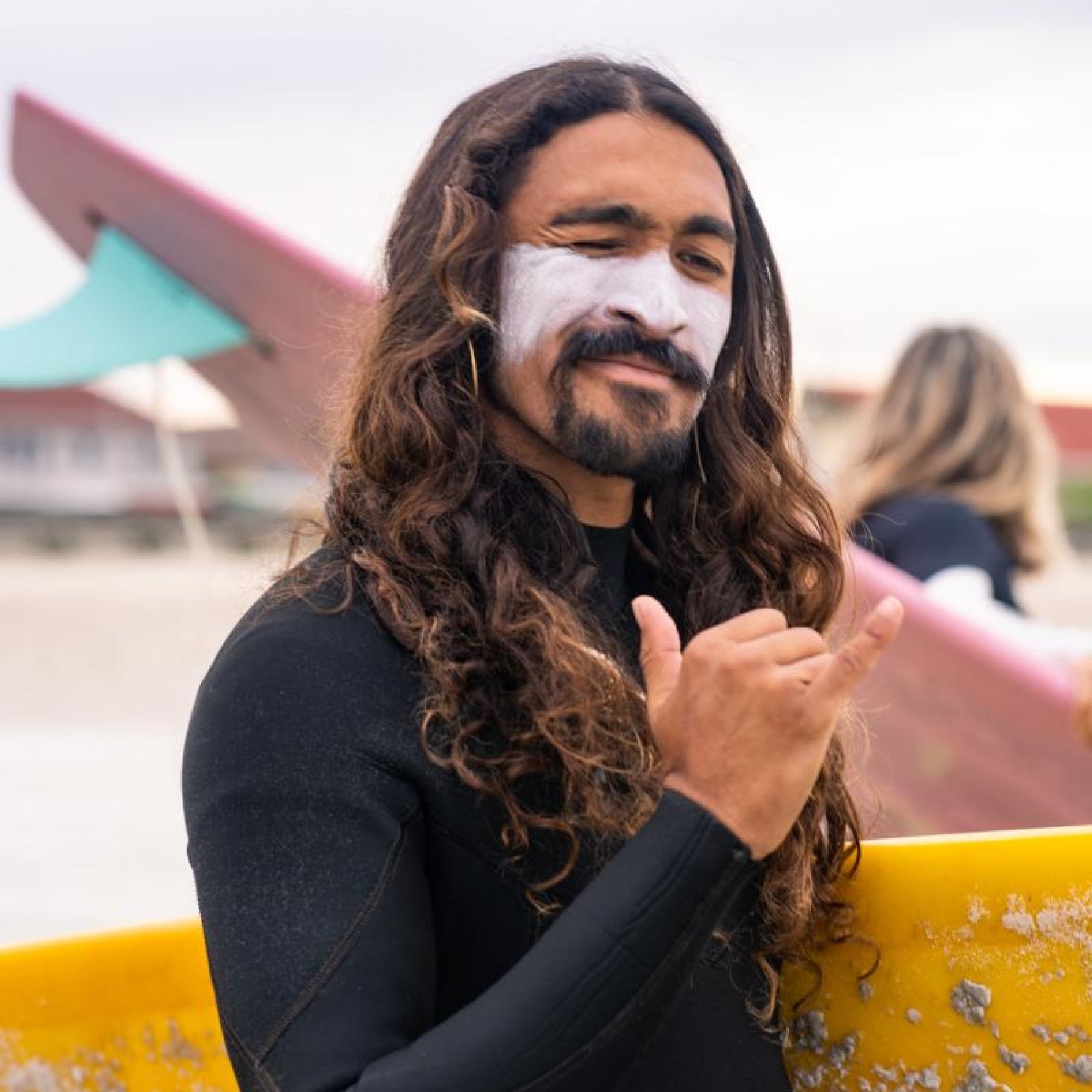 Surfer wearing broad spectrum UVA and UVB sunscreen by Ocean Freedom